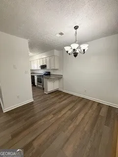 a view of a kitchen with a sink cabinets and wooden floor