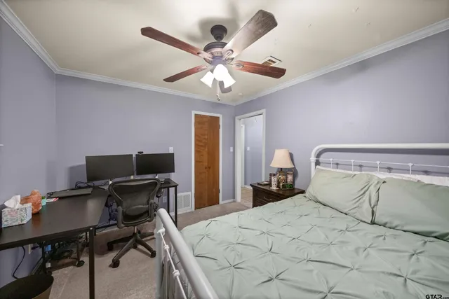 a bedroom with a bed and a desk