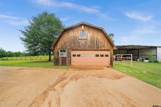 a view of a patio with table and chairs under an umbrella