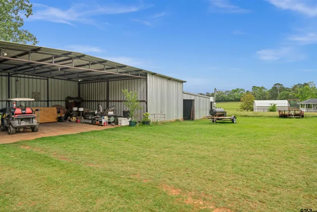 a view of a backyard with garden and entertaining space