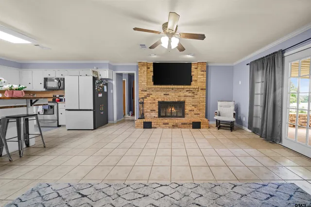 a living room with furniture a flat screen tv and a fireplace