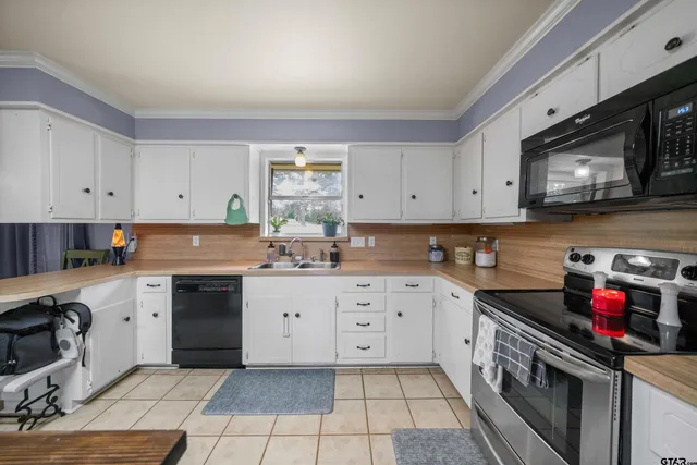 a kitchen with stainless steel appliances granite countertop a sink and cabinets
