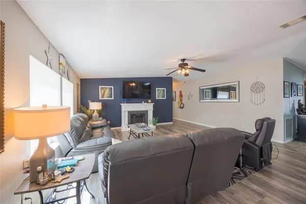 a bedroom with bed and paintings on the wall