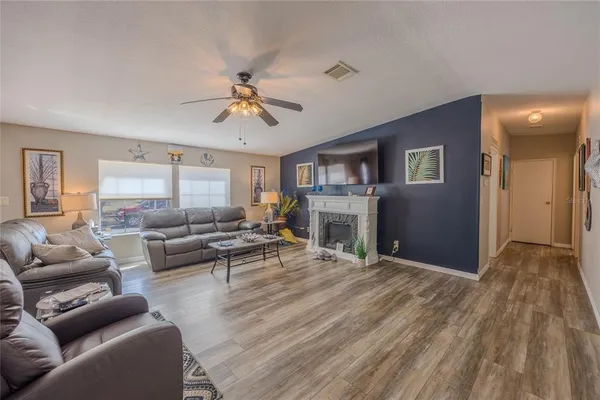 a bedroom with a bed dresser and wooden floor