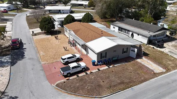 a front view of a building with garden and seating area