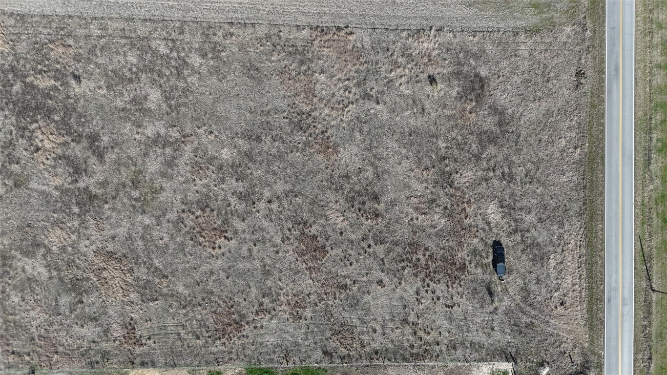 16024 Wells Road Manor, TX 78653 - Photo 12 of 14 a bathroom with a shower curtain
