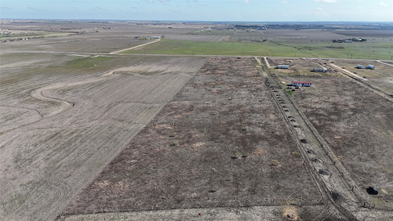 16024 Wells Road Manor, TX 78653 - Photo 6 of 14 a view of a dry yard with wooden floor