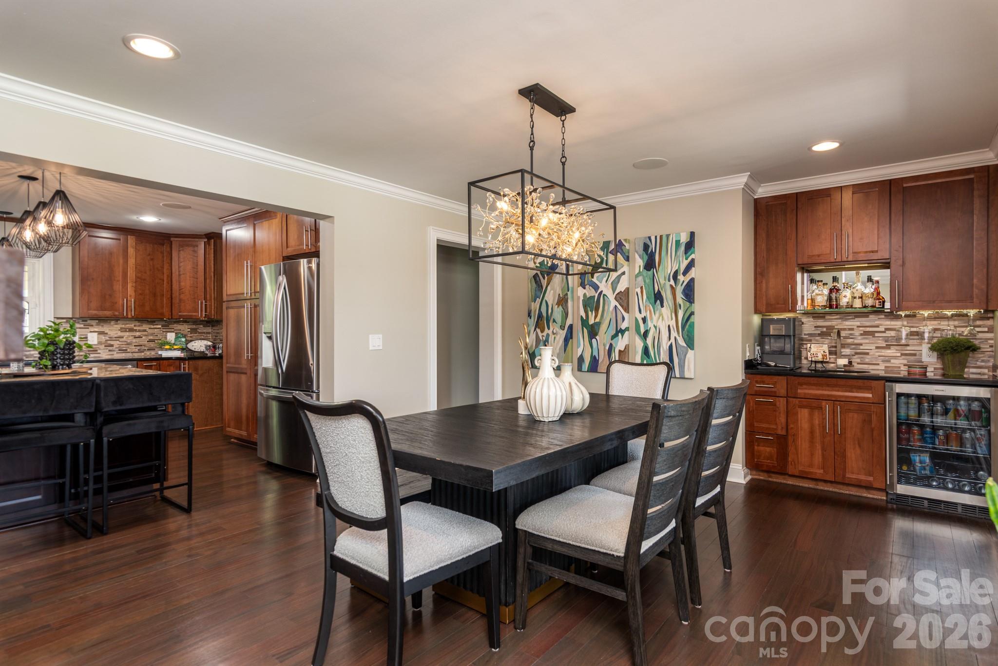 7144 Lynbrook Creek Road Denver, NC 28037 - Photo 12 of 47 a view of a dining room and livingroom with furniture wooden floor a chandelier