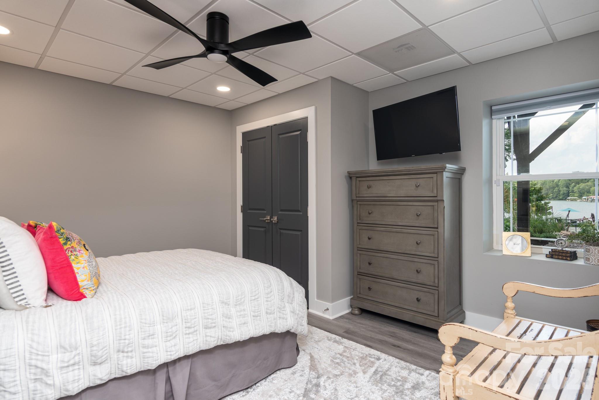 7144 Lynbrook Creek Road Denver, NC 28037 - Photo 25 of 47 a bedroom with a bed and a flat screen tv