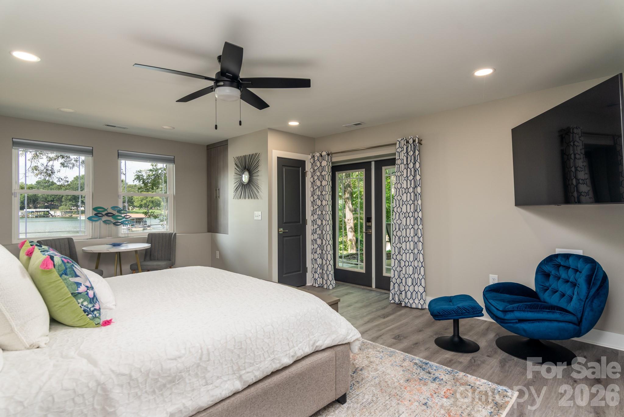 7144 Lynbrook Creek Road Denver, NC 28037 - Photo 30 of 47 a bedroom with a bed a window and a chandelier