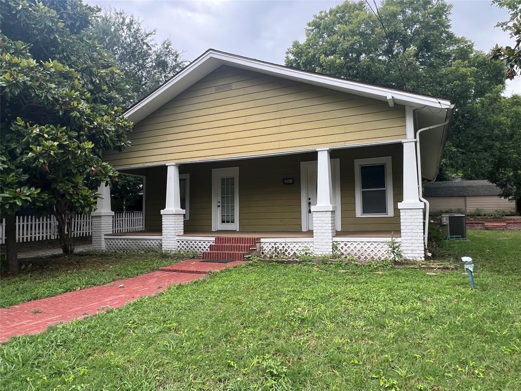 a front view of a house with a yard and porch