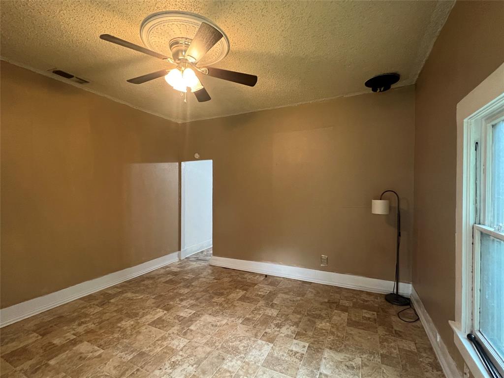 311 West Spring Street Weatherford, TX 76086 - Photo 3 of 15 a view of a room with window and ceiling fan