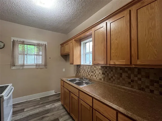 a bathroom with a sink a mirror and a window