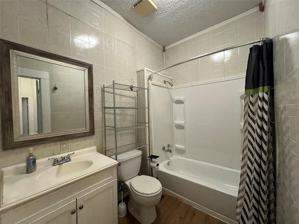 311 West Spring Street Weatherford, TX 76086 - Photo 8 of 15 a bathroom with a sink toilet and shower