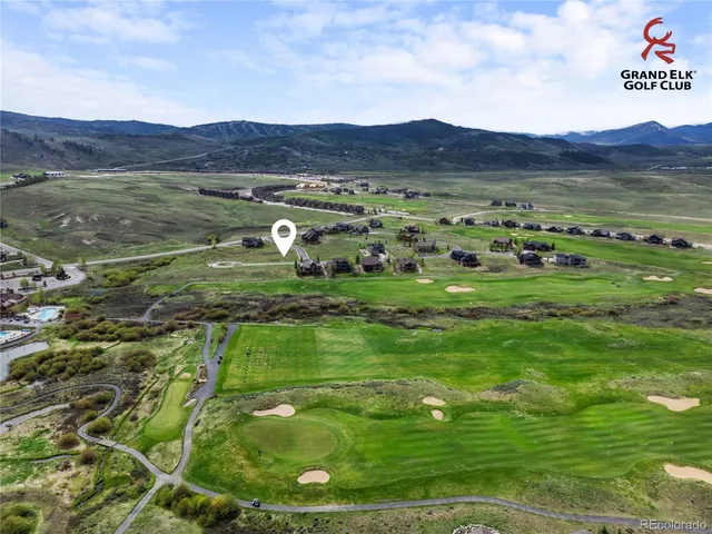 a view of an aerial view of residential houses with outdoor space and trees
