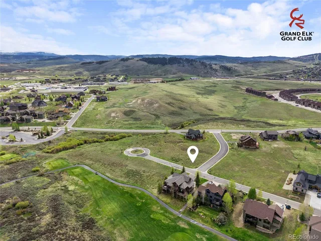 an aerial view of a house with a ocean view