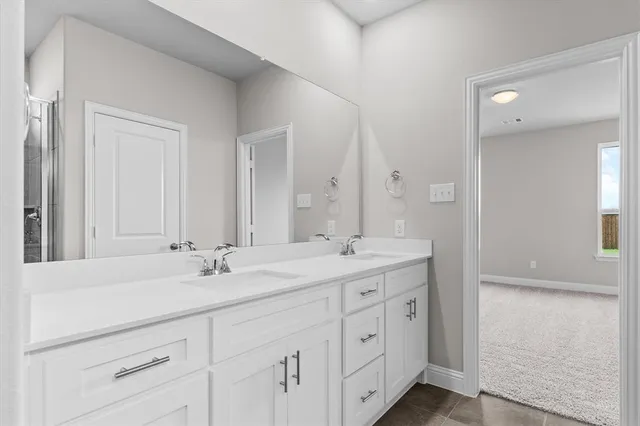 a bathroom with double sink and a mirror