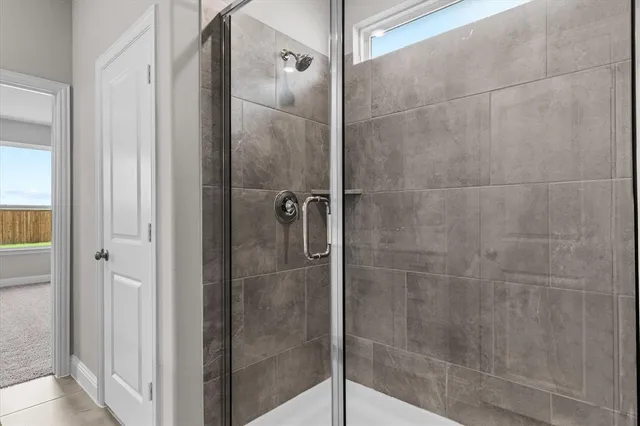 a bathroom with a glass shower door