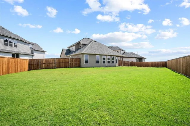 a front view of house with yard and garage