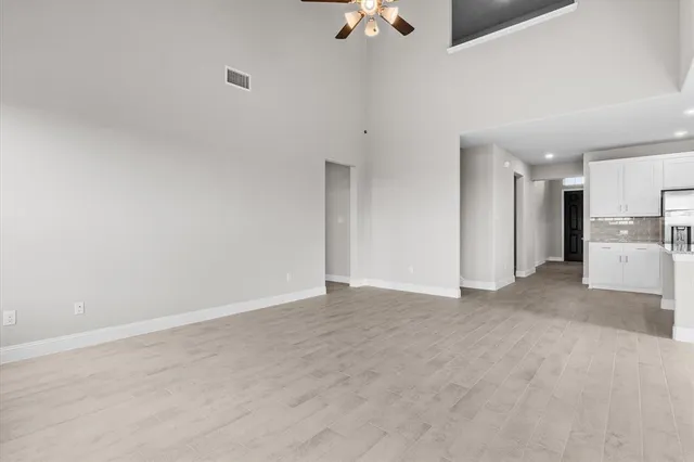 a view of a kitchen with a refrigerator a kitchen counter top space and cabinets