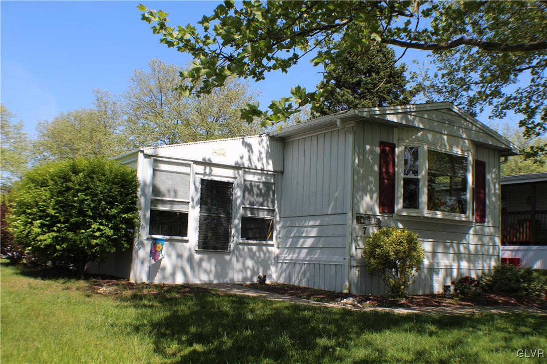7 Springridge Road Bath, PA 18014 - Photo 1 of 17 a view of a house with brick walls and a yard with plants