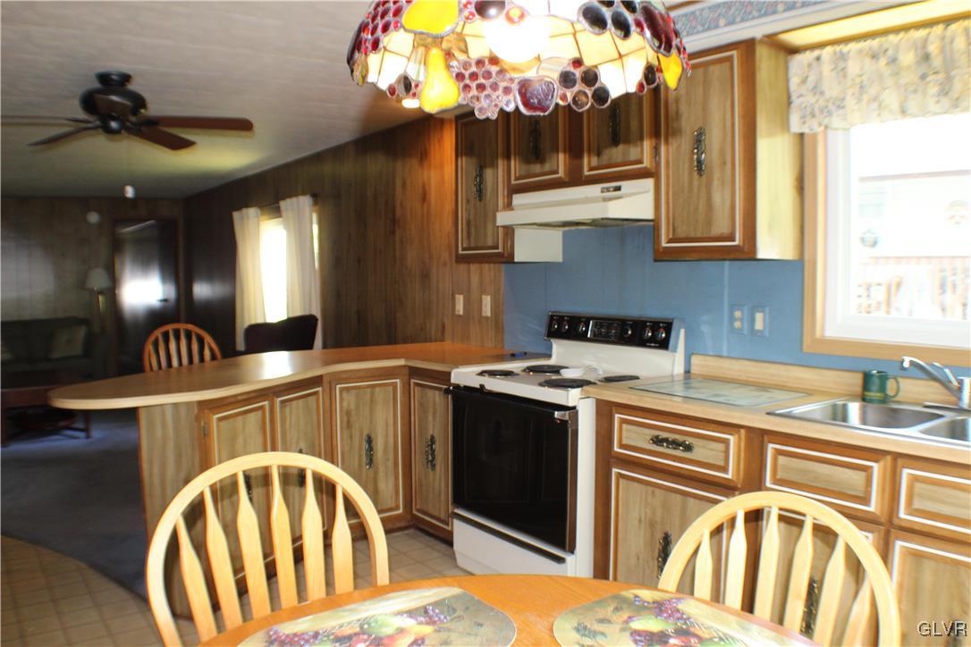 7 Springridge Road Bath, PA 18014 - Photo 4 of 17 a kitchen with a stove a sink and a chandelier