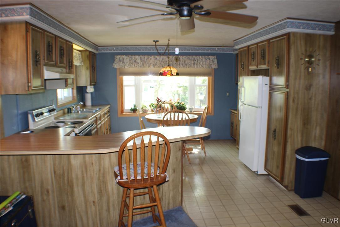 7 Springridge Road Bath, PA 18014 - Photo 6 of 17 a dining room with furniture a chandelier and wooden floor