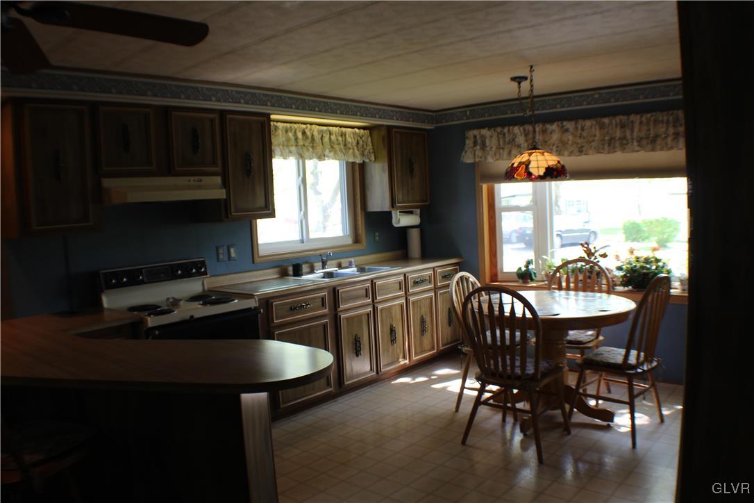 7 Springridge Road Bath, PA 18014 - Photo 8 of 17 a kitchen with a table chairs stove and microwave