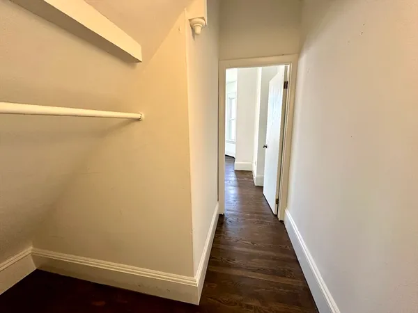 a view of a room with wooden floor and a window