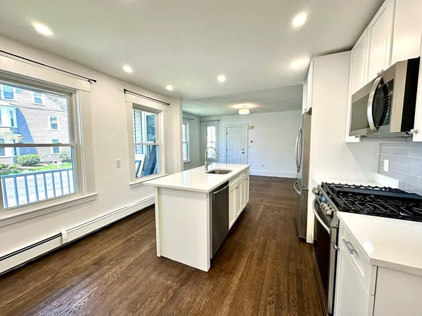 a kitchen with stainless steel appliances granite countertop a stove and a sink
