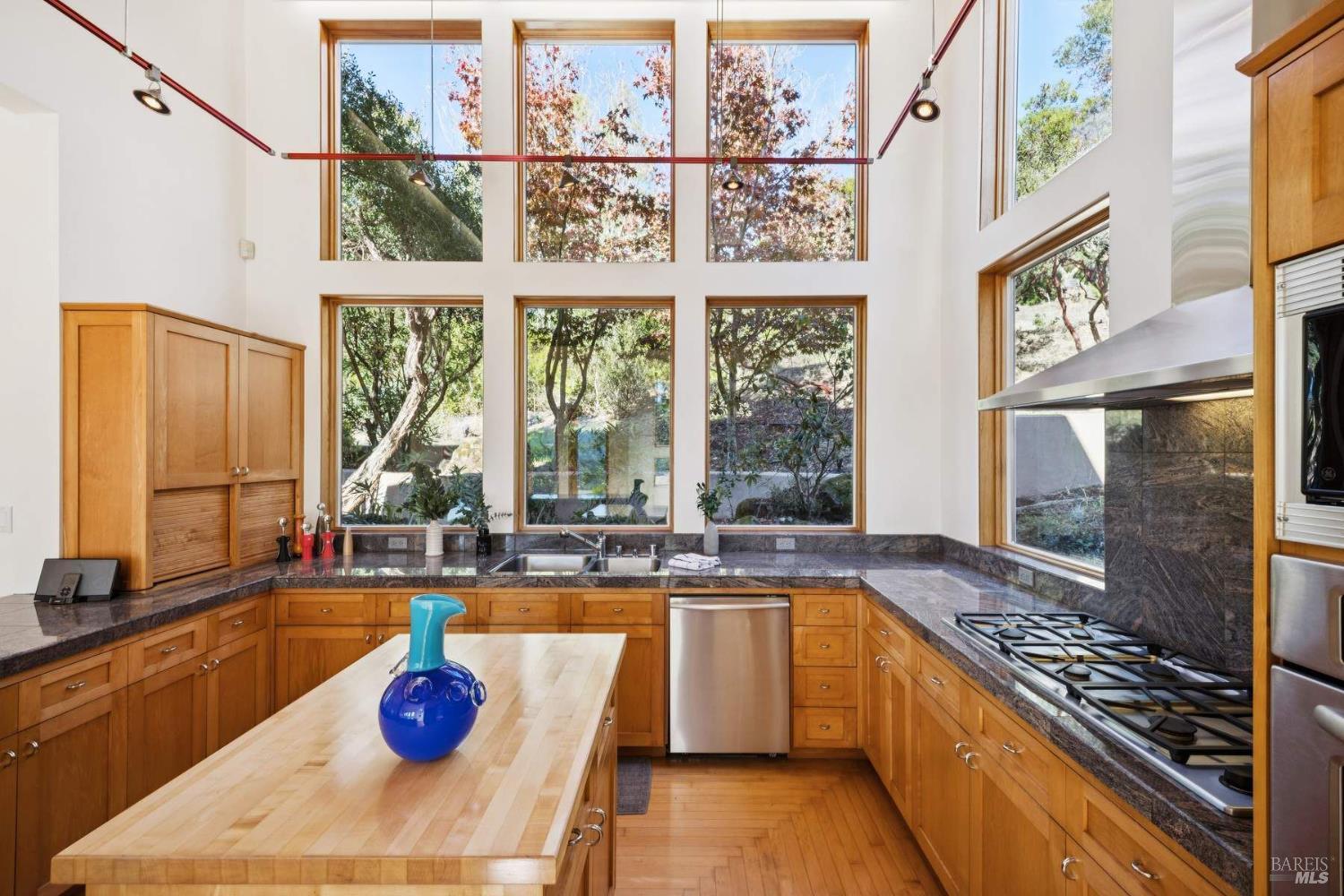 10300 Slattery Road Kenwood, CA 95452 - Photo 18 of 35 a kitchen with a stove a sink and a wooden floor