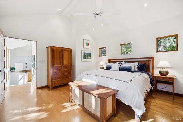 a bedroom with a bed and wooden floor