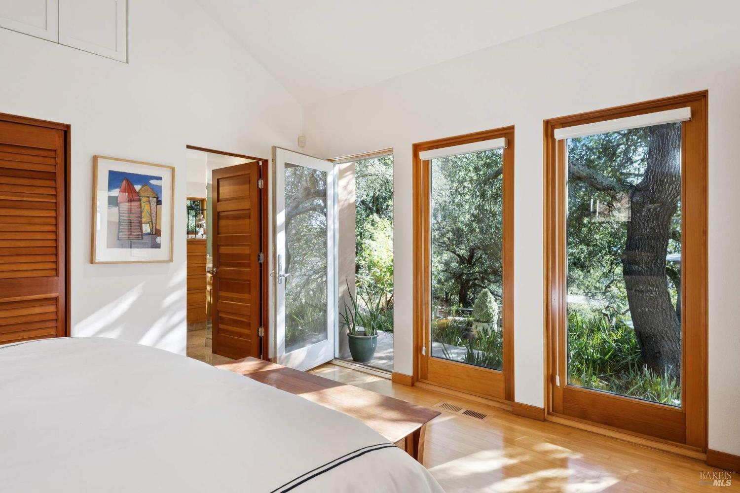 10300 Slattery Road Kenwood, CA 95452 - Photo 22 of 35 a bedroom with a bed and wooden floor