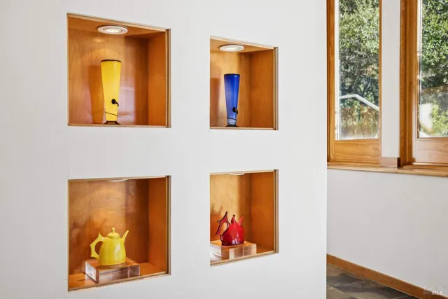 a living room with furniture and floor to ceiling window