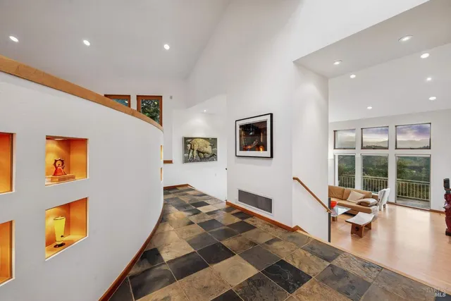 a living room with furniture and floor to ceiling windows