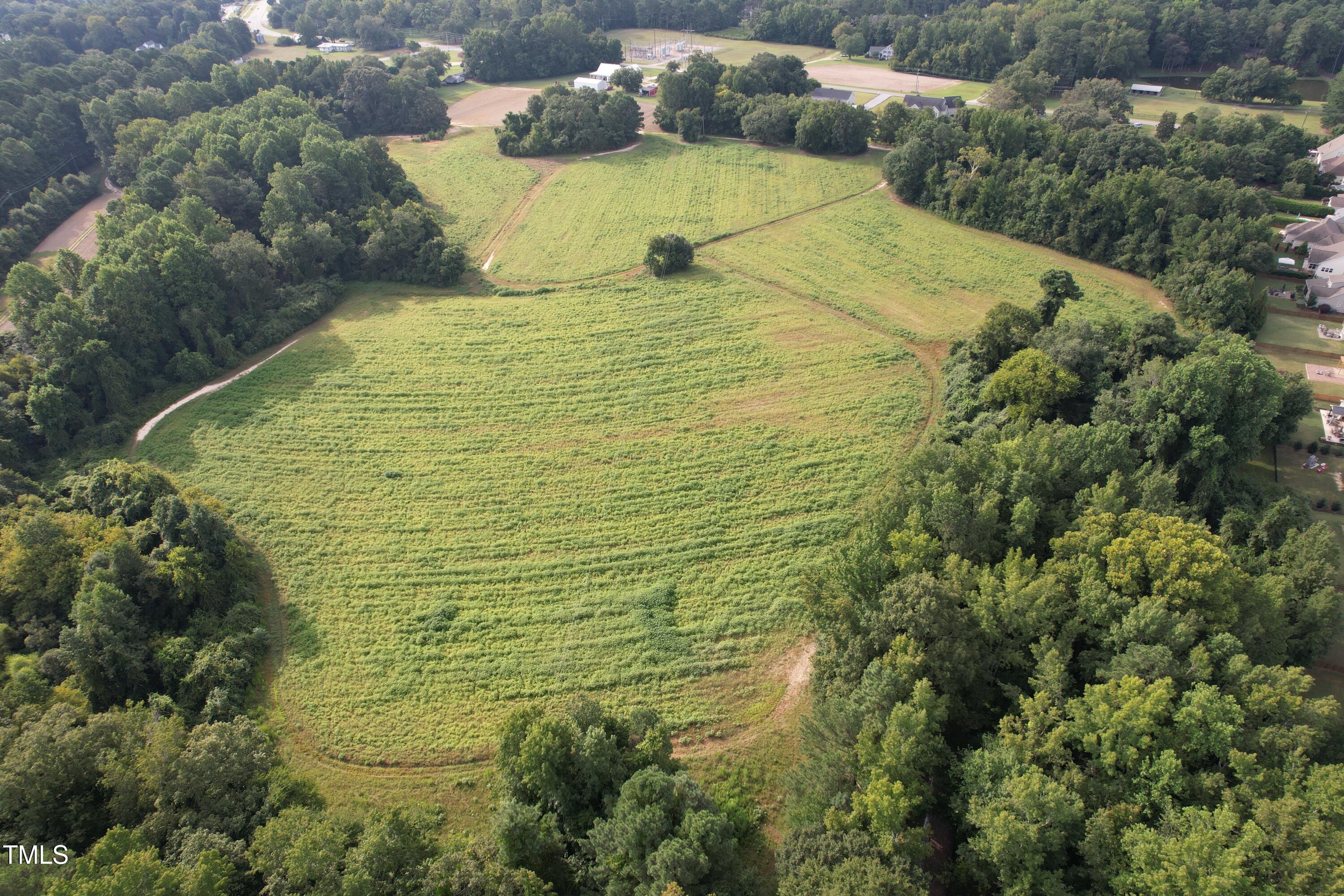 1103 Holland Road Fuquay-Varina, NC 27526 - Photo 1 of 10 a blue swimming pool is sitting in the middle of a lake