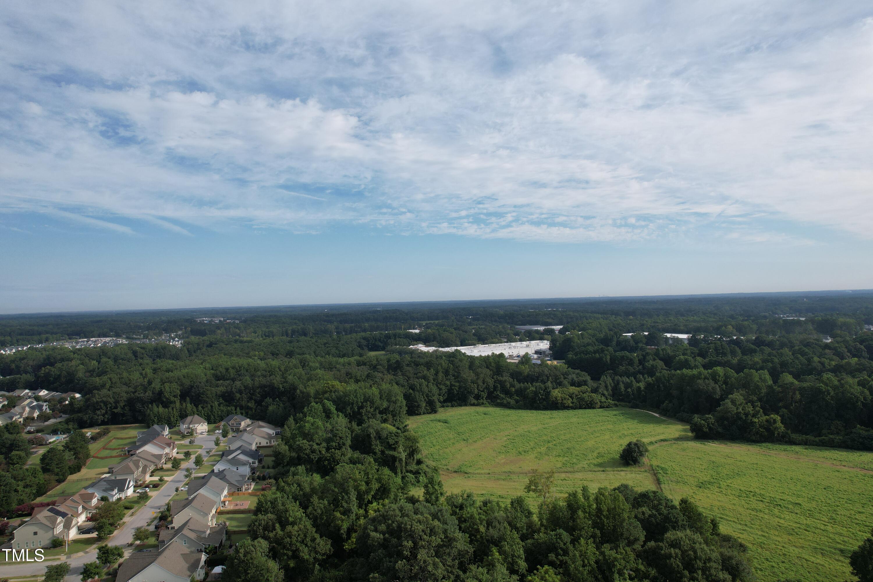 1103 Holland Road Fuquay-Varina, NC 27526 - Photo 2 of 10 an aerial view of a city and trees