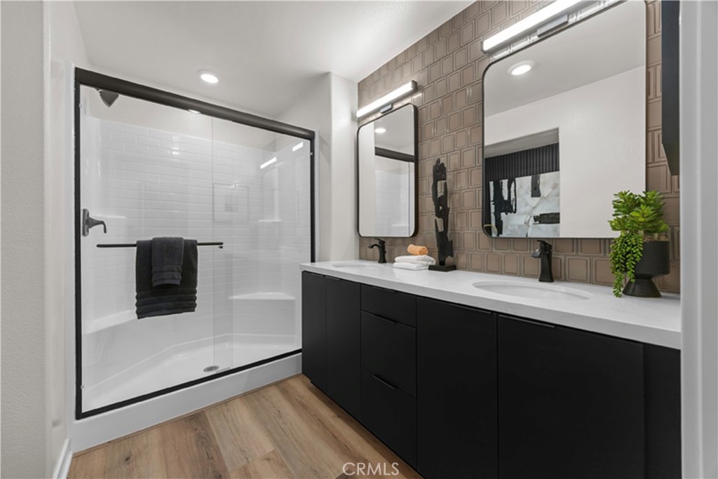 7363 Suva Street Downey, CA 90240 - Photo 13 of 13 a bathroom with a double vanity sink and mirror