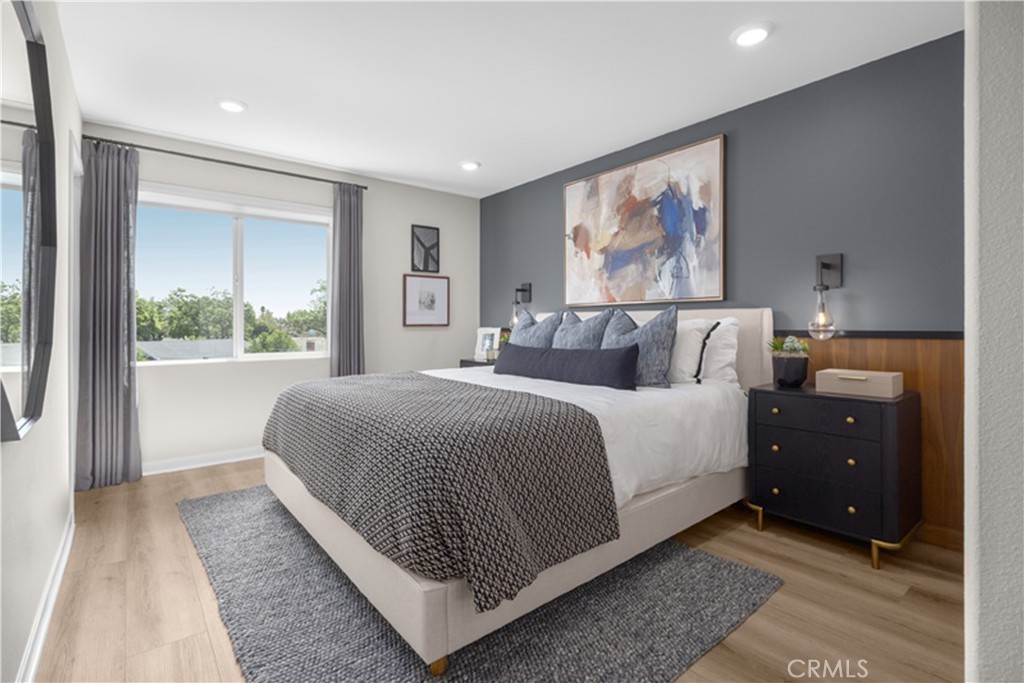 7363 Suva Street Downey, CA 90240 - Photo 7 of 13 a bedroom with a large bed and a large window