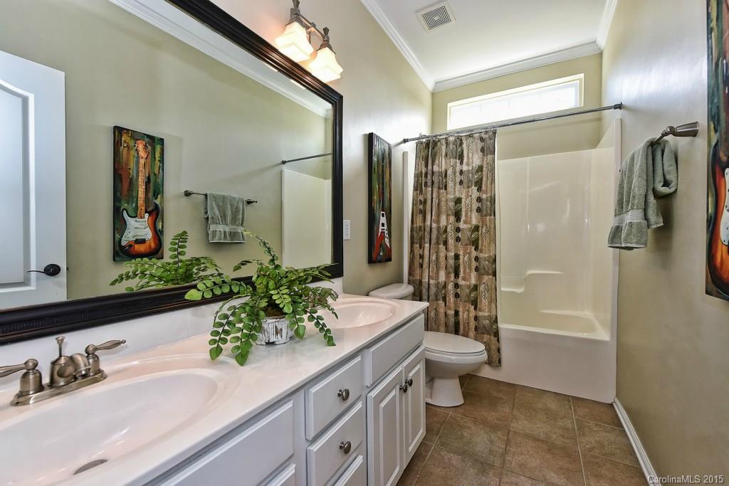 914 Treasure Court Fort Mill, SC 29708 - Photo 22 of 24 a bathroom with a granite countertop sink a toilet a mirror a vanity and shower