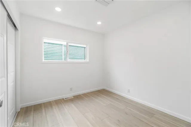 a bedroom with a bed and flat screen tv