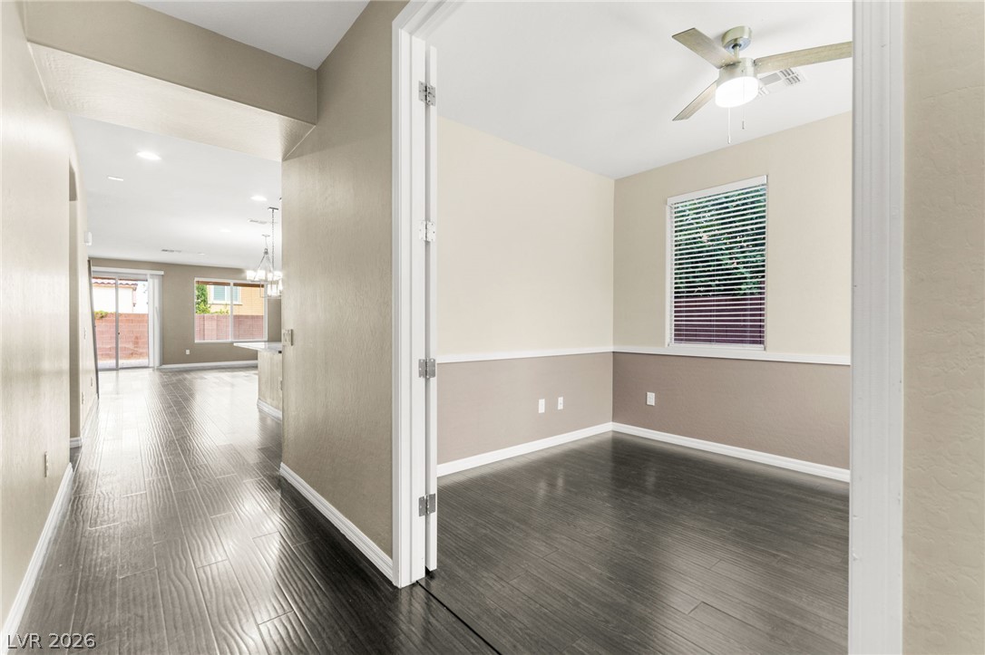 11048 Prairie Grove Road Las Vegas, NV 89179 - Photo 7 of 75 Hardwood floors stretch through an open-concept living area with abundant natural light.
