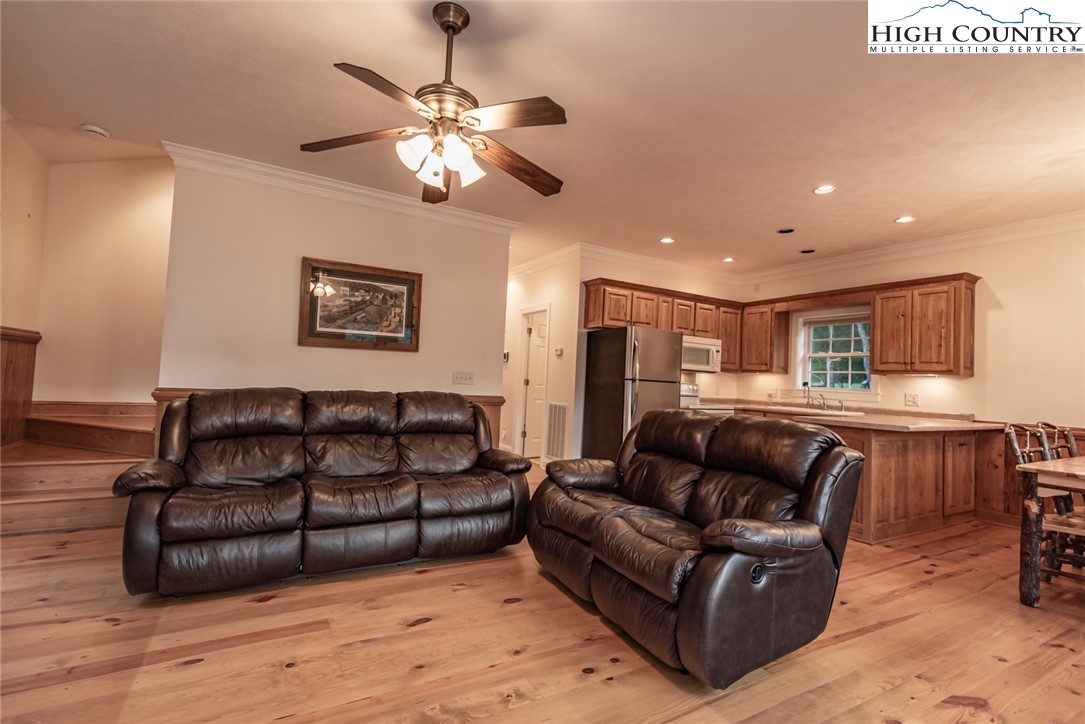 1195 Long Branch Road Lansing, NC 28643 - Photo 19 of 31 a living room with furniture and a wooden floor
