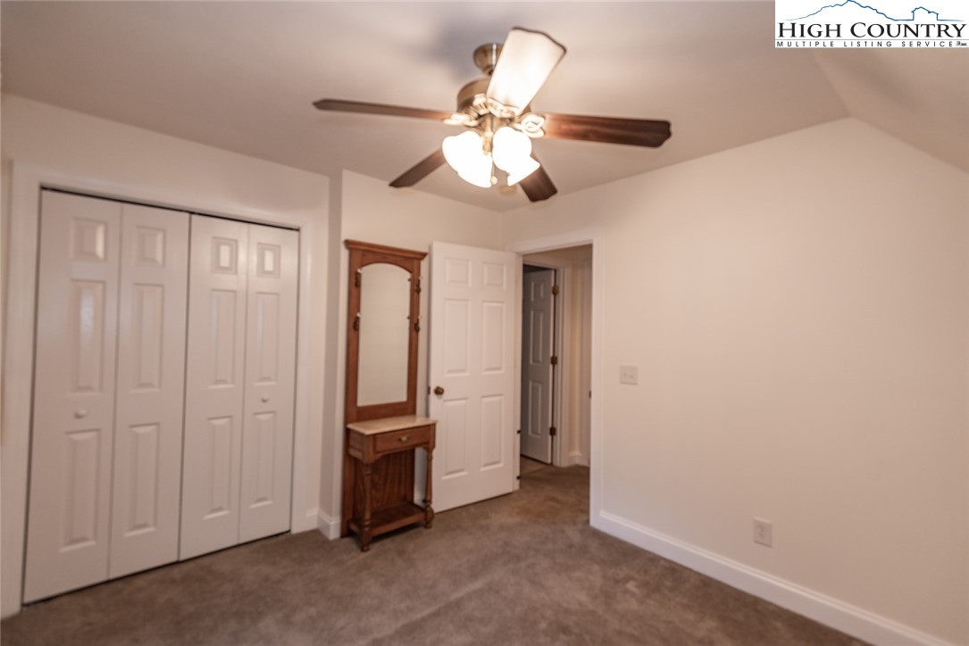 1195 Long Branch Road Lansing, NC 28643 - Photo 26 of 31 a view of an empty room with chandelier fan