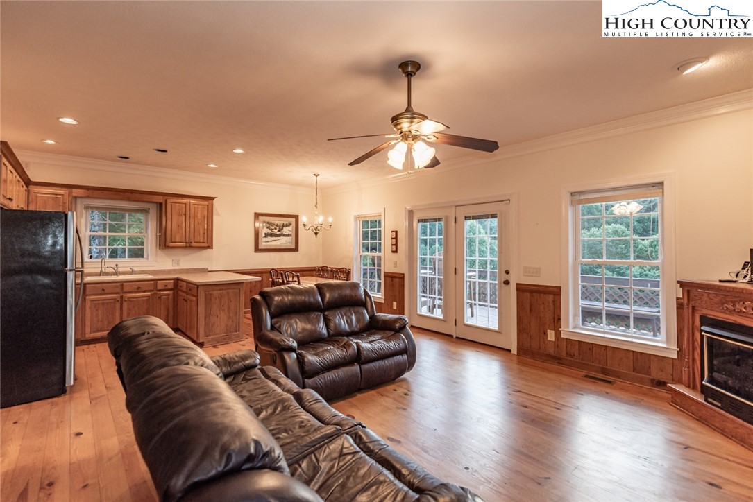 1195 Long Branch Road Lansing, NC 28643 - Photo 4 of 31 a living room with furniture ceiling fan and a flat screen tv