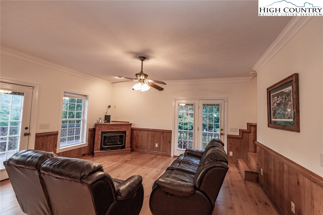 1195 Long Branch Road Lansing, NC 28643 - Photo 6 of 31 a living room with furniture a fireplace and a flat screen tv