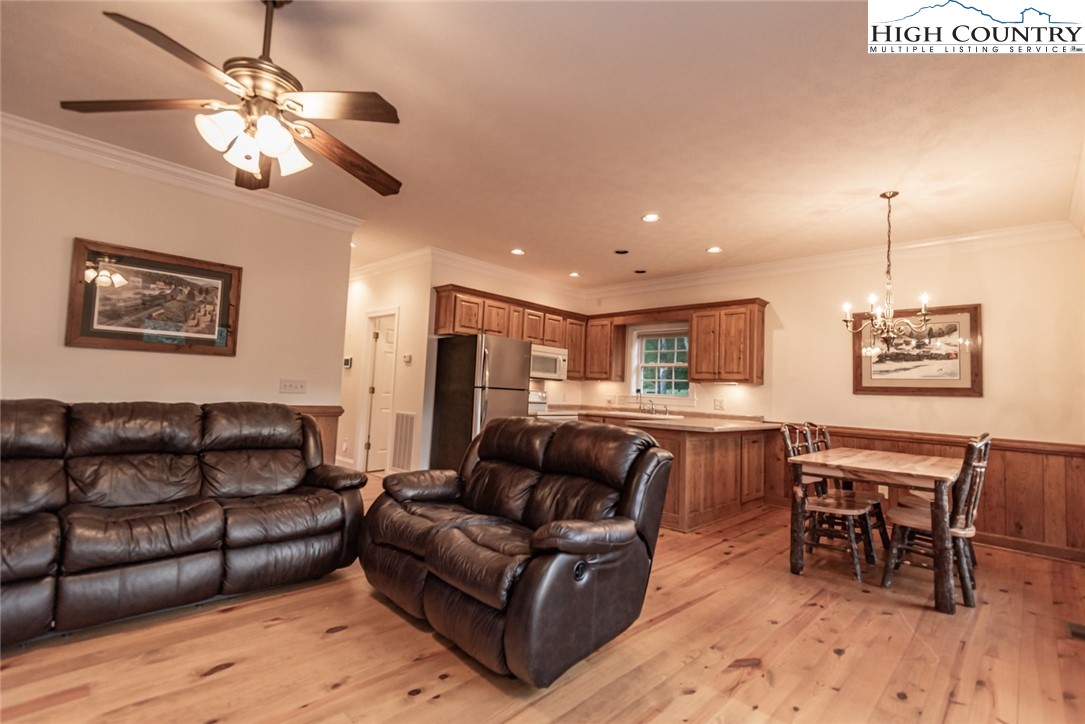 1195 Long Branch Road Lansing, NC 28643 - Photo 10 of 31 a living room with furniture a ceiling fan and a window