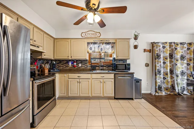 a kitchen with stainless steel appliances granite countertop a refrigerator and a stove top oven