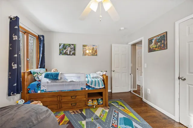a bed room with furniture and a baby crib