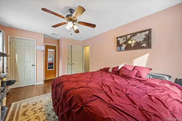 a bedroom with a large bed and a chandelier